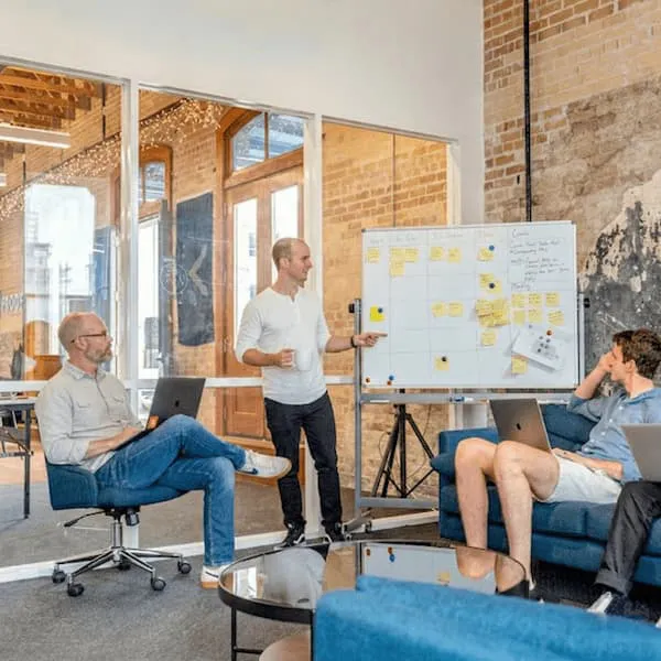 Senior web developers Ross Merriam and Mitch Leblanc giving a client presentation in front of a white board